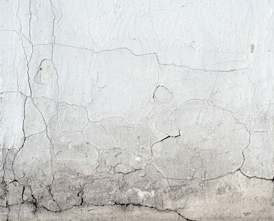 Foundation cracks and water damage on a home's foundation